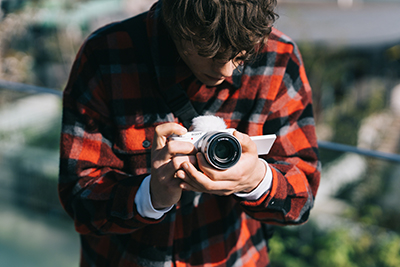 Male taking image of city