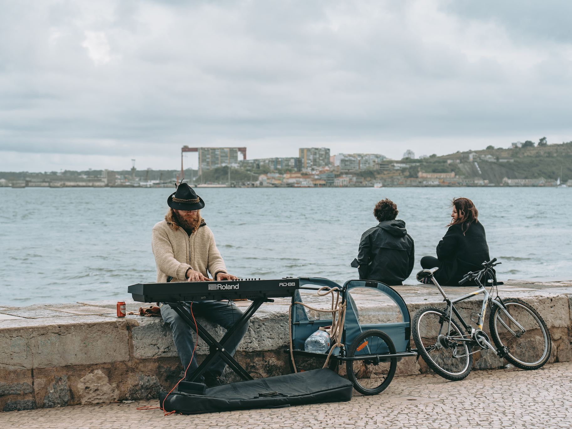 Street musician playing the keyboard by the sea